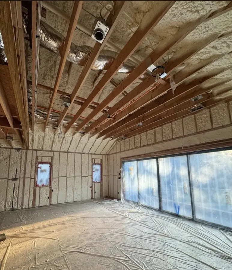 Interior walls and ceiling insulated with spray foam during new construction in Laconia